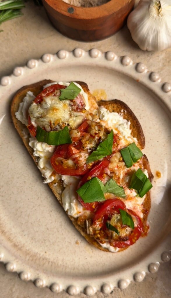 Cheesy Roasted Tomato on a round tan plate.