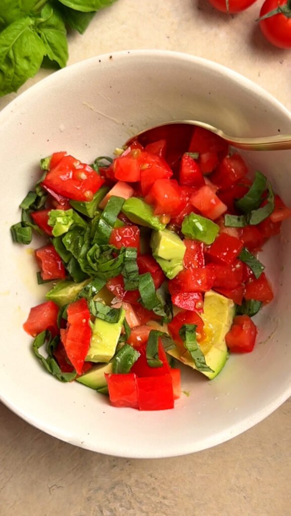 Bowl with chopped tomatoes and avocado
