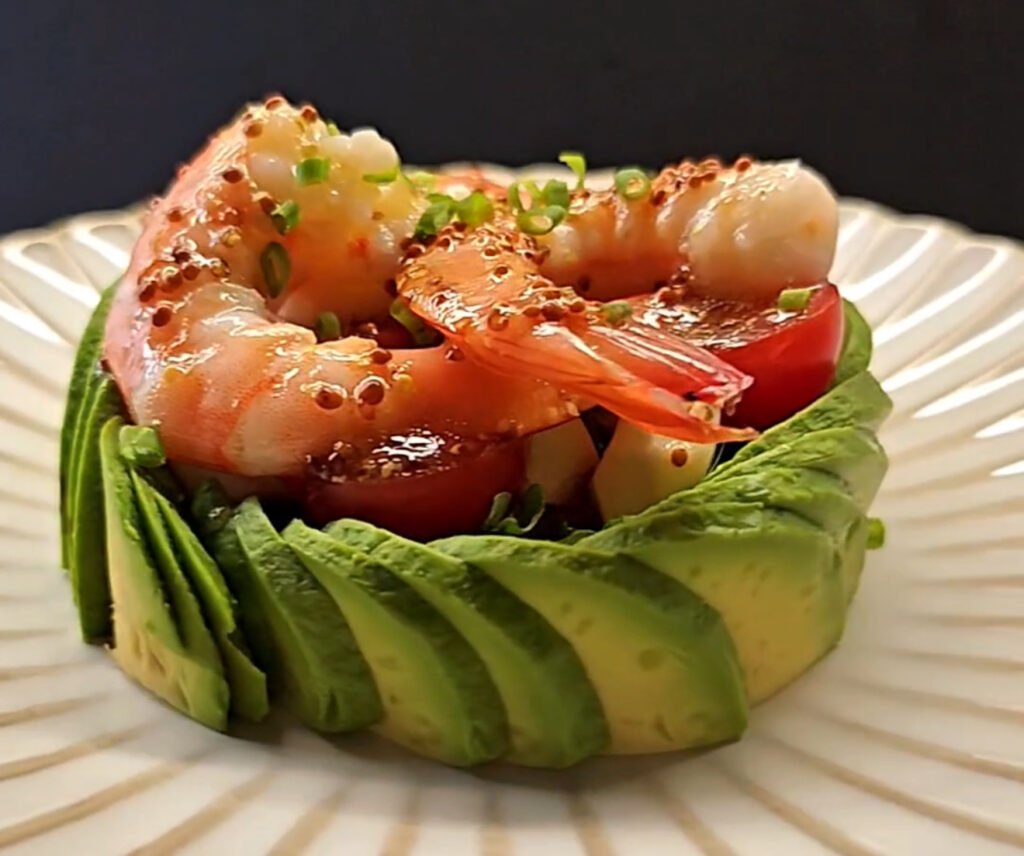 White round plate with avocado and shrimp salad