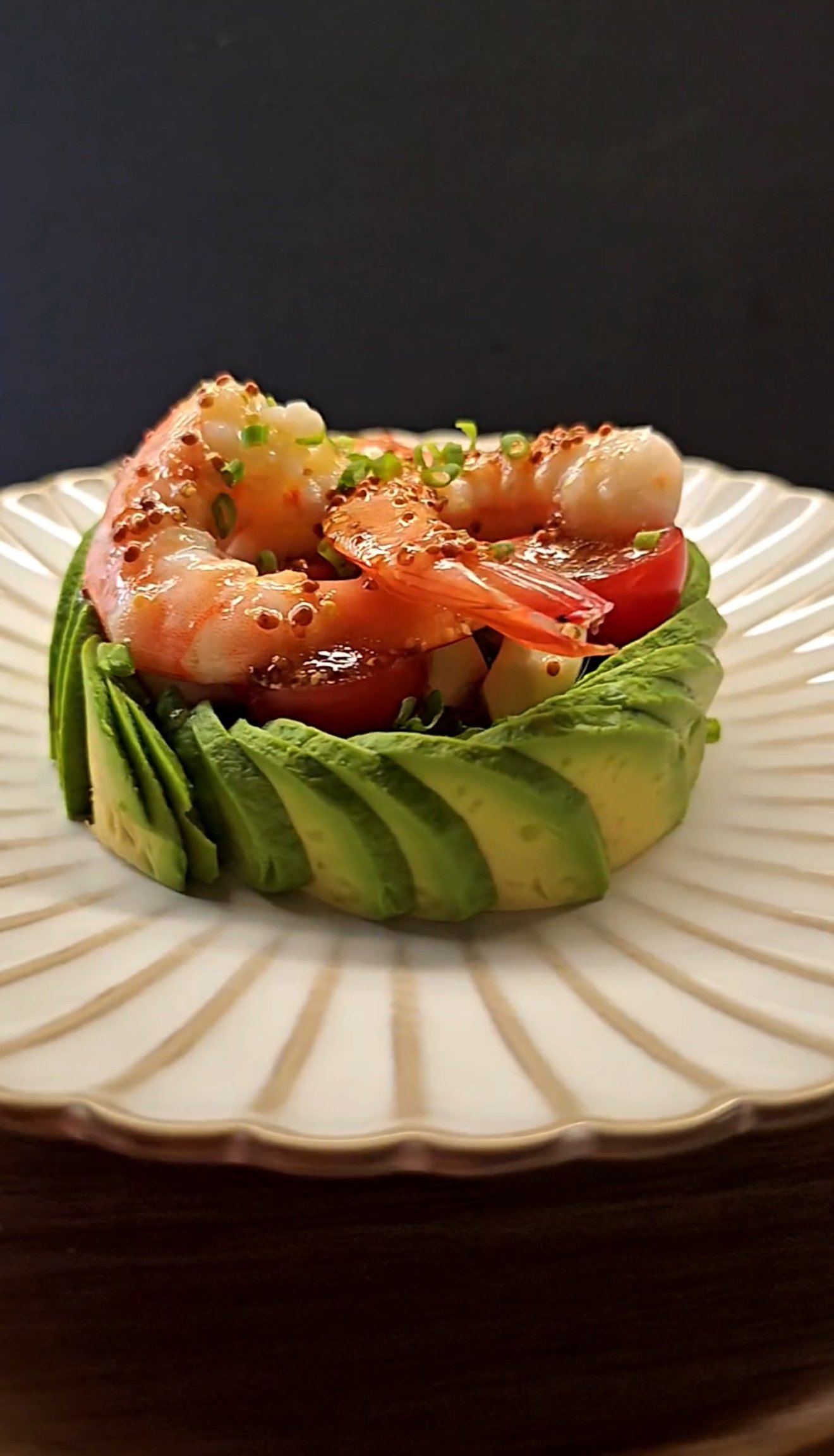 White round plate with avocado and shrimp salad