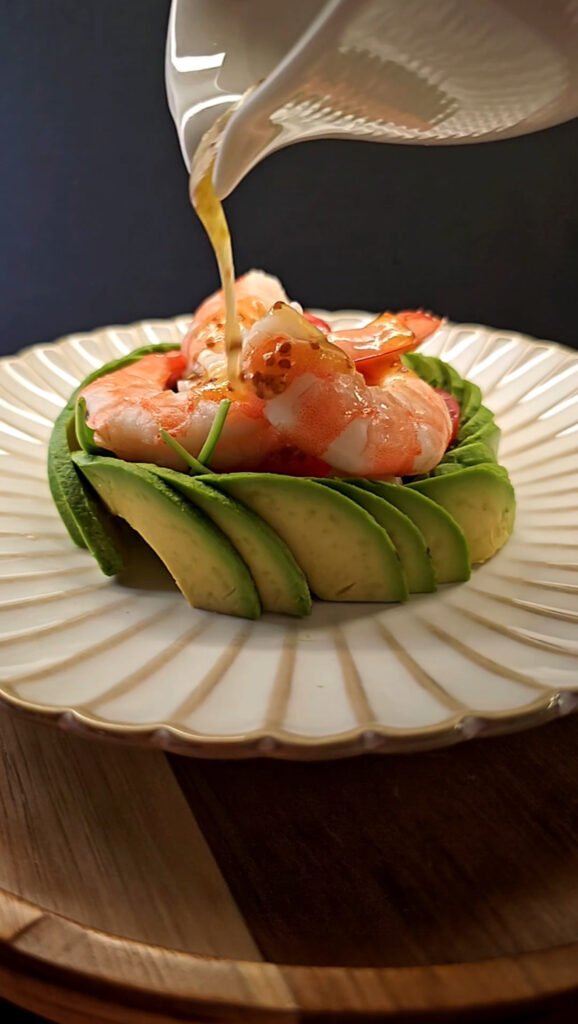 White round plate with avocado and shrimp salad
