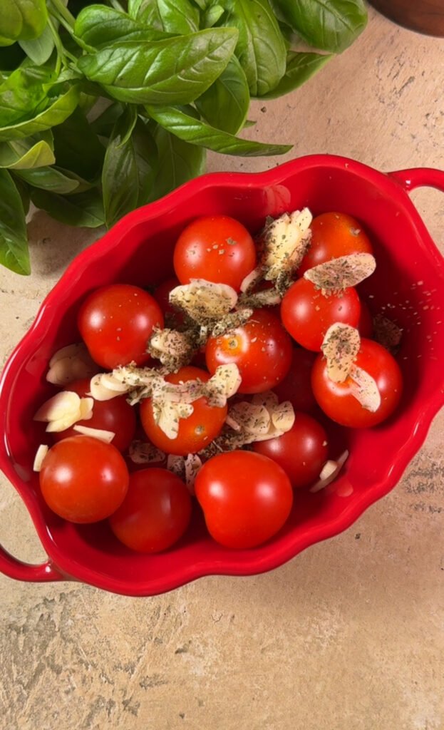 Tomatoes and sliced garlic in a baking dish