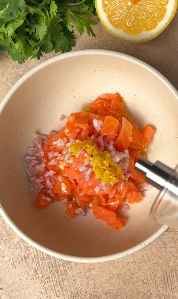 Salmon and chopped chives in a bowl
