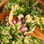 Lemon-Dill Orzo Salad in a wooden bowl. Spoon is on top with some salad