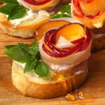Peach and Prosciutto Crostini on a wooden board