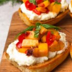 Peach bruschetta topped with juicy peaches, cherry tomatoes, and basil on creamy ricotta spread over golden sourdough toast, drizzled with honey