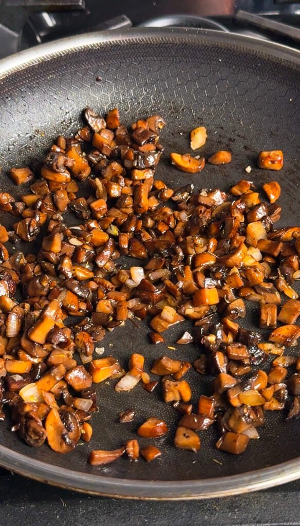 Deeply browned, glossy mushrooms and shallots after finishing with butter, soy sauce, balsamic, and thyme