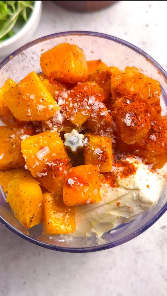 Roasted butternut squash, cream cheese, smoked paprika, and flaky salt added to a food processor before blending into a mousse.