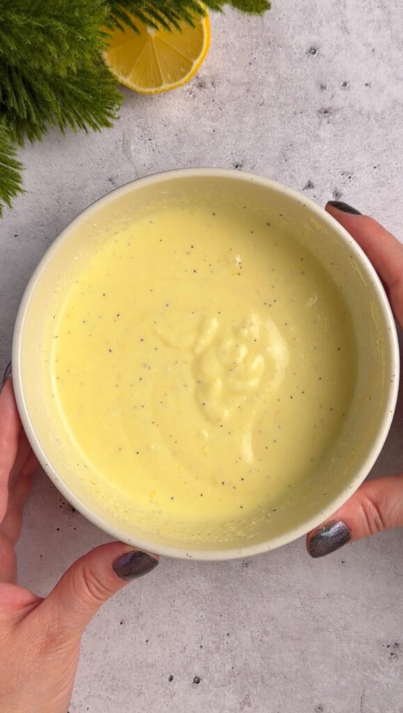 Smooth whipped ricotta mixture with egg and lemon zest, mixed until creamy and ready for baking