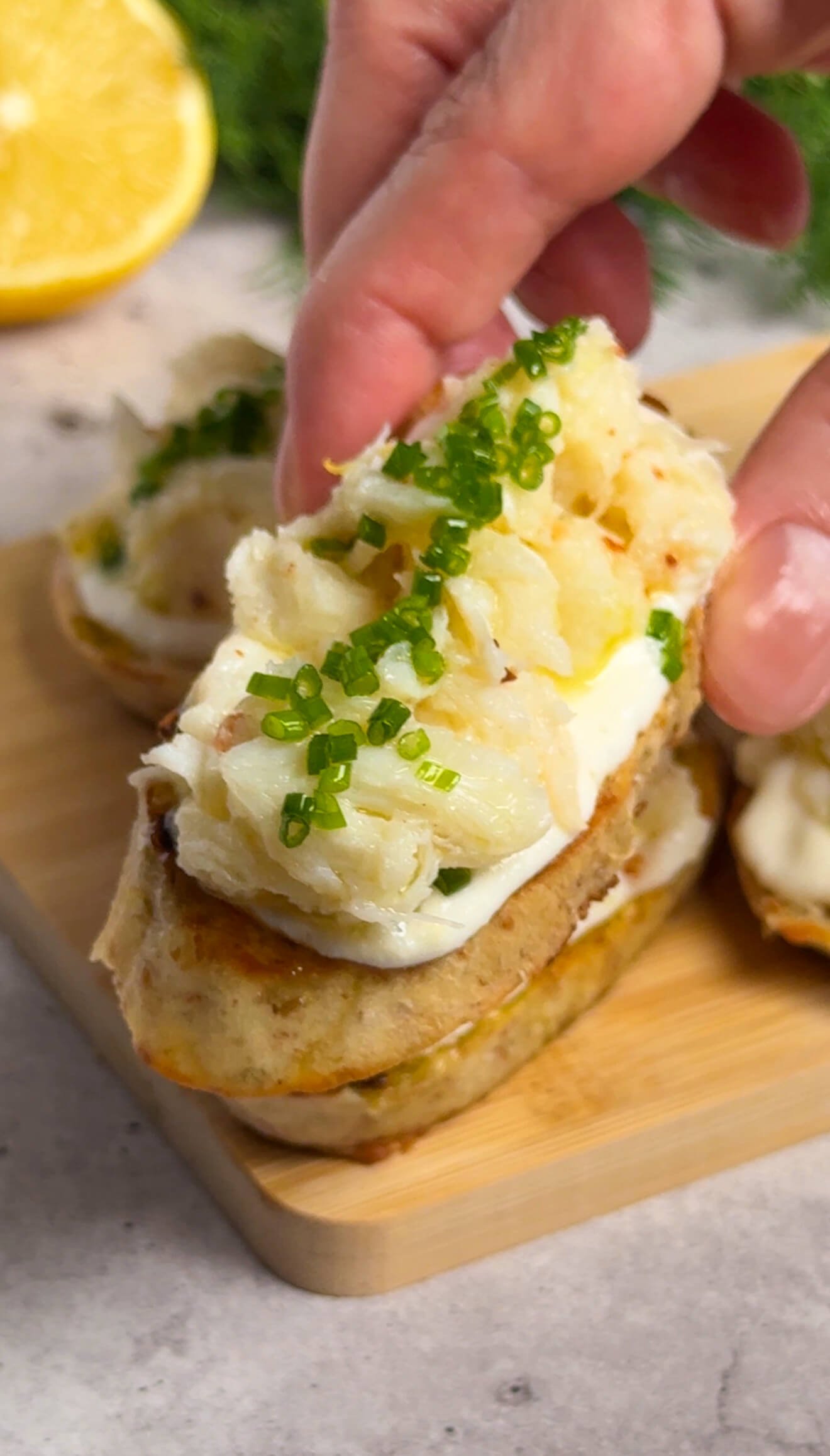 Elegant crab crostini with whipped lemon ricotta and chive oil drizzle