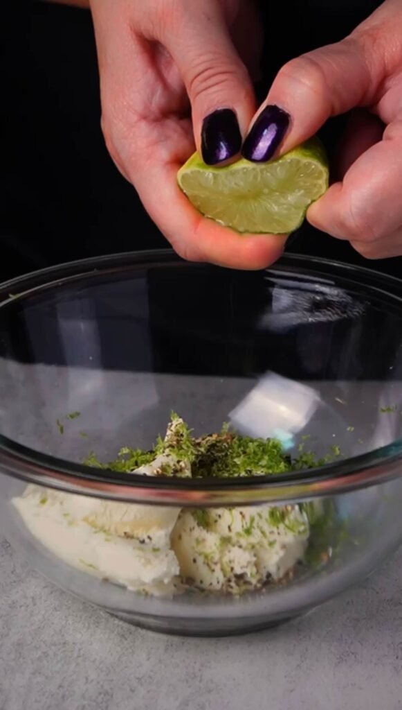 Fresh lime juice and zest being added to sour cream for lime cream filling