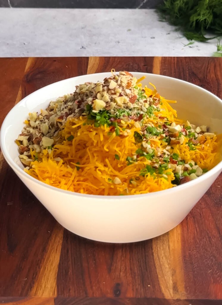 Shredded cheddar, chopped almonds, bacon, and chives combined for a Million Dollar cheese dip