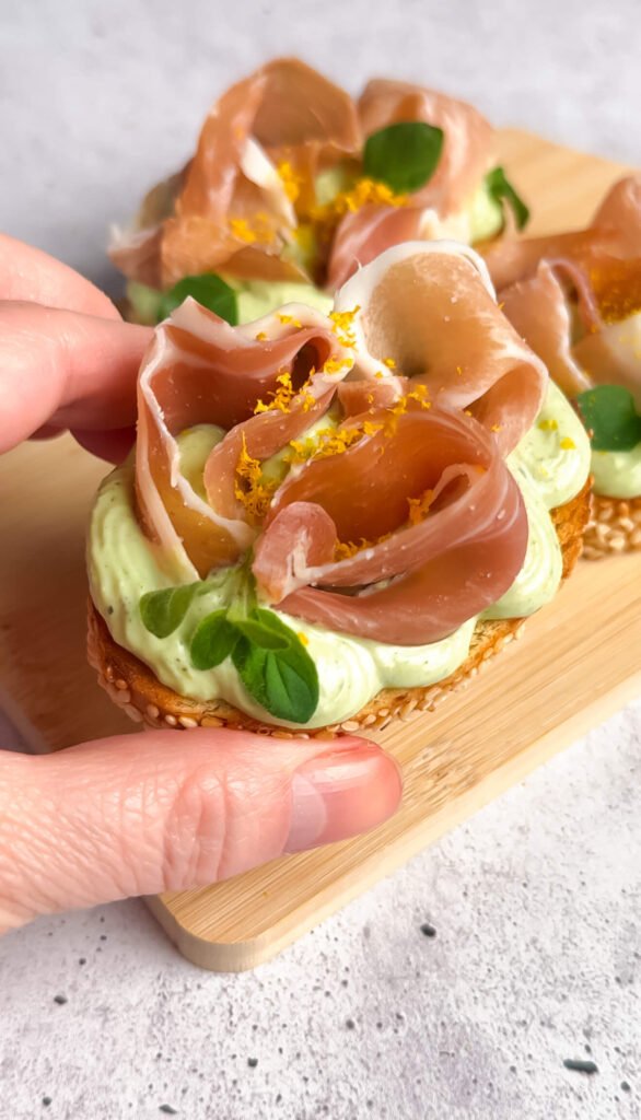 Close-up of crostini with whipped ricotta and prosciutto appetizer