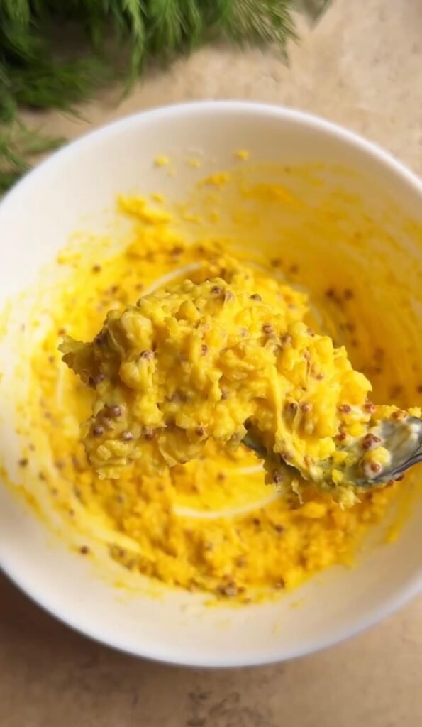 creamy deviled egg yolk filling mixed with whole grain mustard and mayonnaise