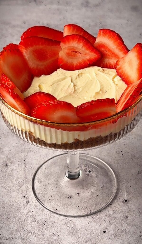 Strawberry mascarpone parfait topped with fresh strawberries arranged in a circular pattern