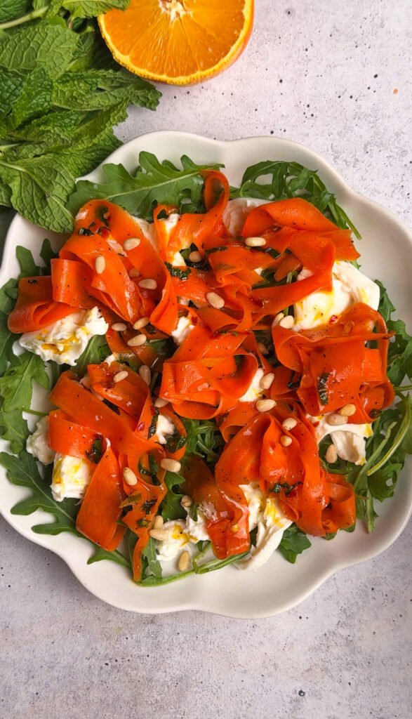 Roasted carrot burrata salad with arugula, toasted pine nuts, and citrus carrot glaze
