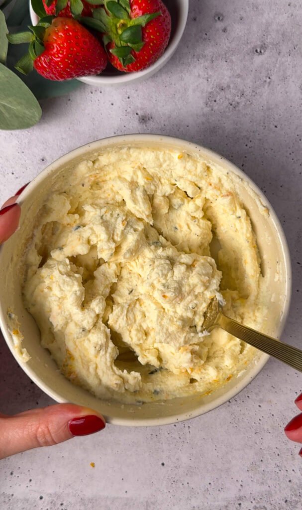 Creamy ricotta and goat cheese mixture prepared for sweet and savory strawberry prosciutto cheesecake dip appetizer.