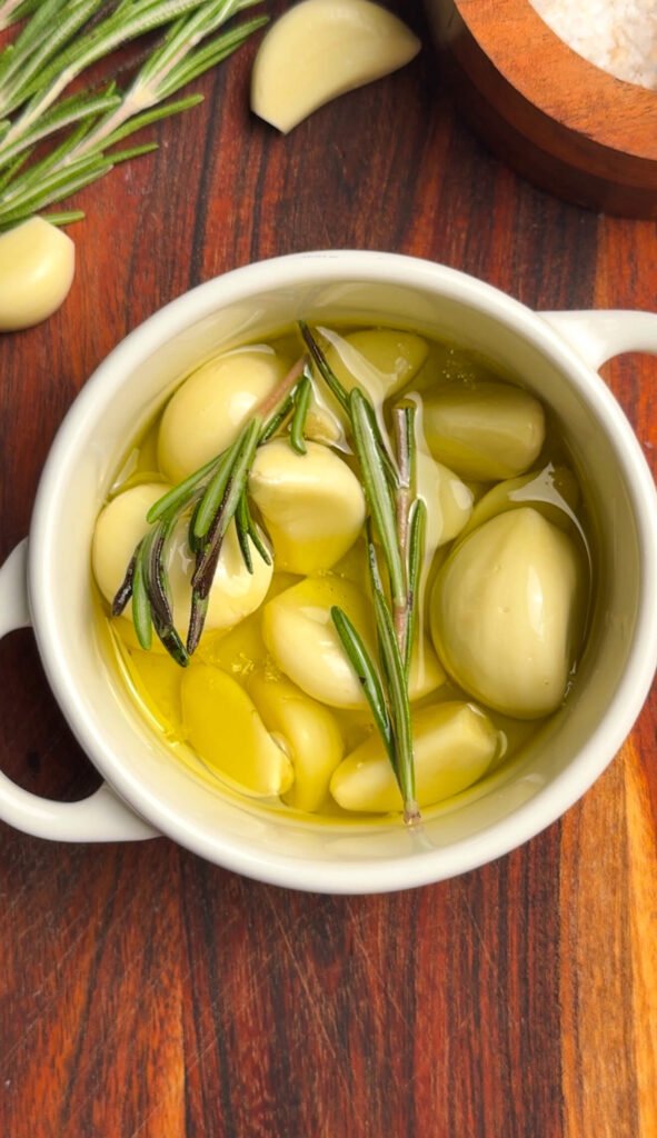 Garlic confit slowly cooked in olive oil with rosemary