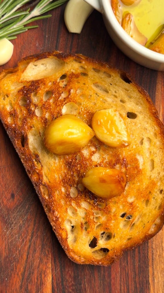 Golden toasted sourdough topped with soft garlic confit cloves for gourmet toast