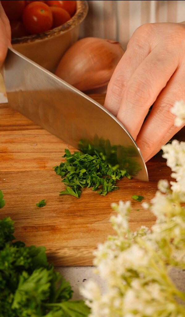 finely chopping parsley for easy marinated tomatoes recipe preparation