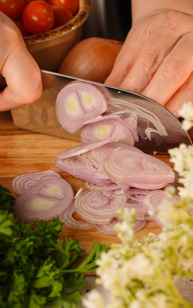 thinly sliced shallot for quick marinated cherry tomatoes recipe close up