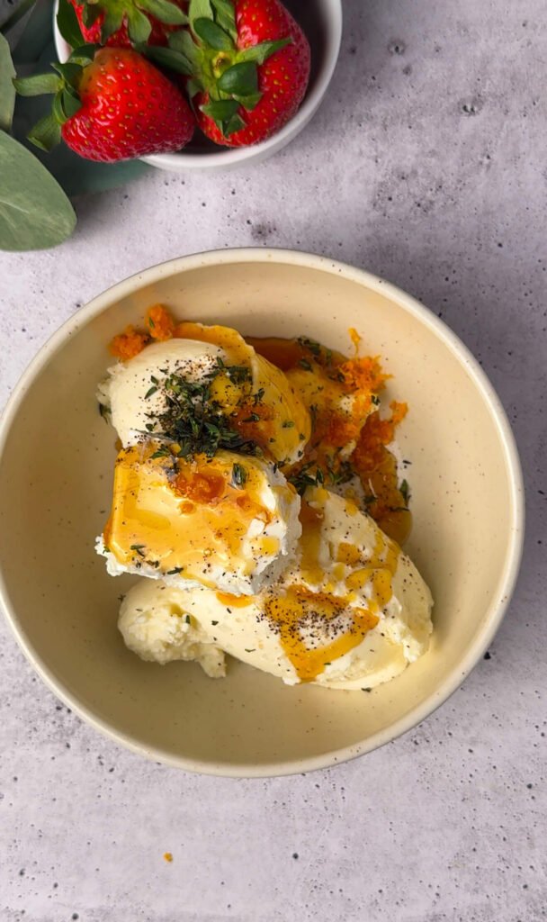 Ricotta and goat cheese mixture with honey, orange zest, thyme, salt, and pepper for creamy strawberry prosciutto cheesecake dip filling.