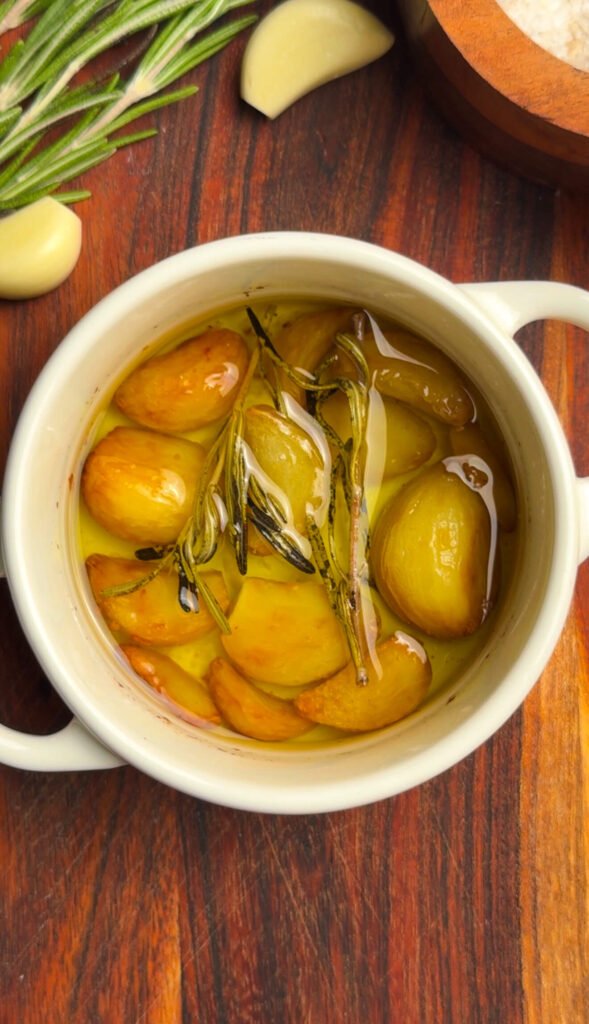 Roasted garlic confit cloves in olive oil with rosemary
