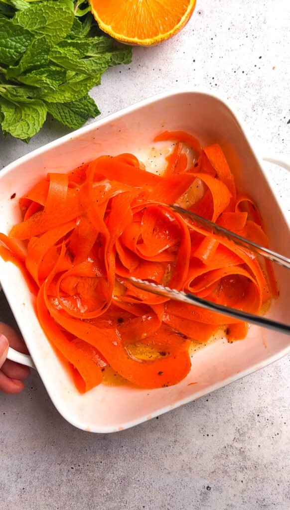 Thin carrot ribbons tossed with citrus glaze before roasting for roasted carrot burrata salad
