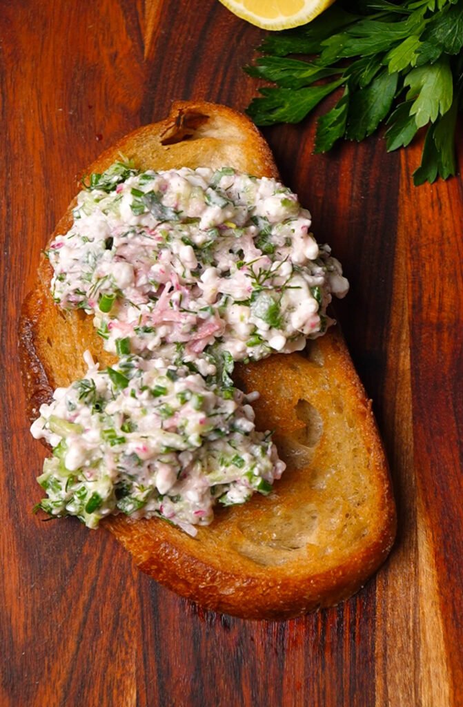 Herbed cottage cheese mixture spread over toasted sourdough bread