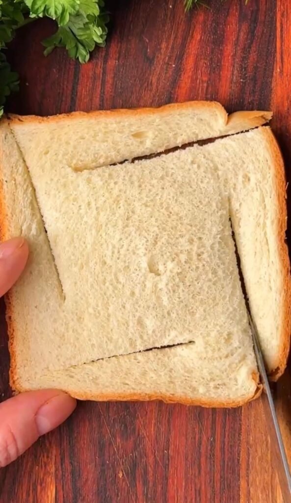 Cutting soft sandwich bread into a windmill pattern with four slits toward the center