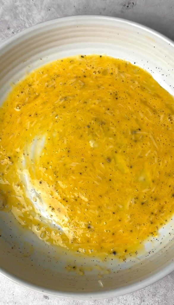 whisked egg with grated parmesan and black pepper for crispy sourdough toast