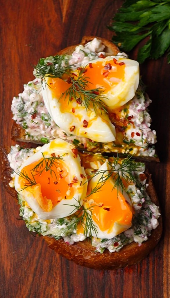 Fresh spring toast with cottage cheese, herbs, and soft-boiled eggs on sourdough