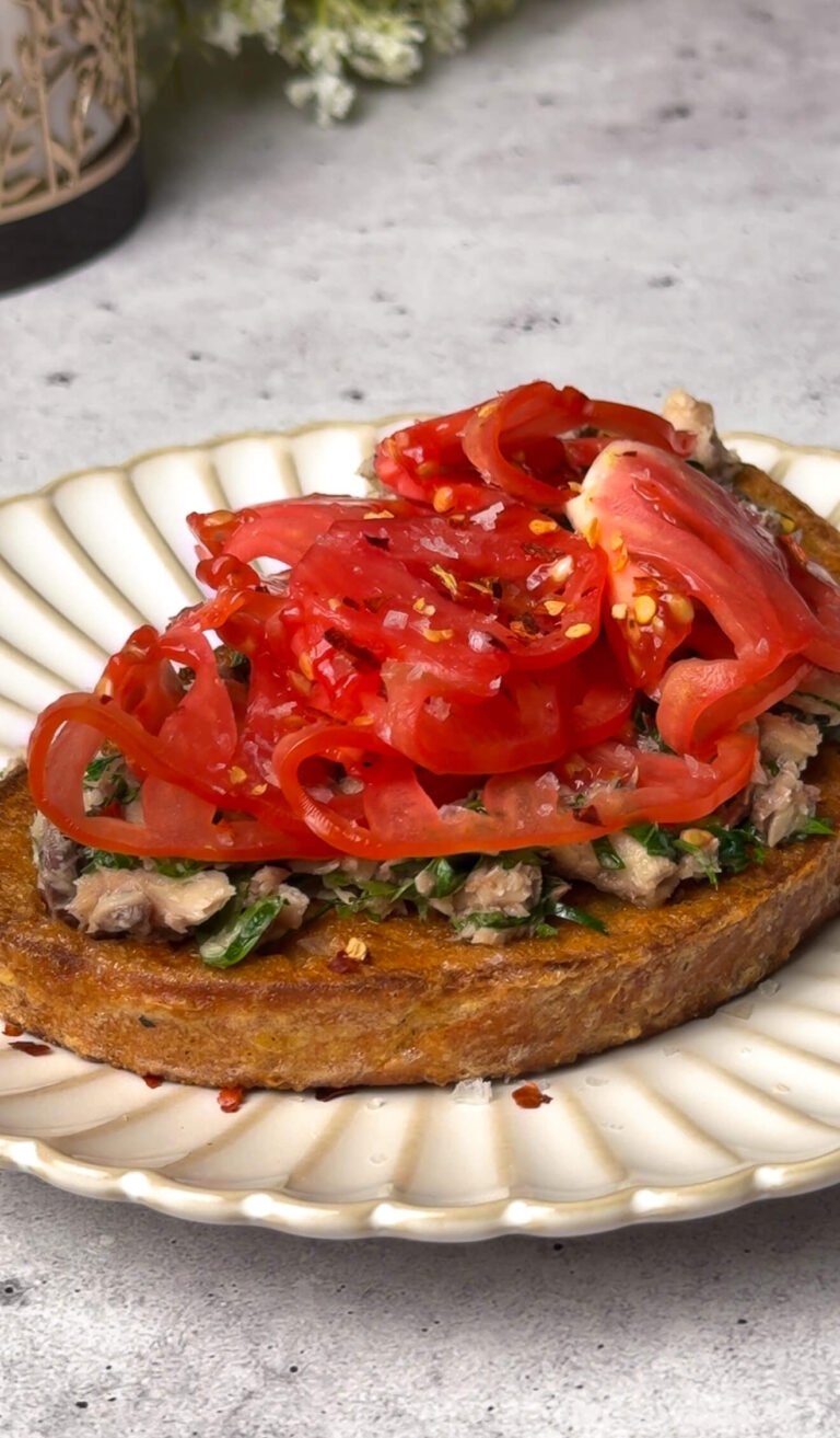heirloom tomato toast with lemon herb sardines on crispy sourdough