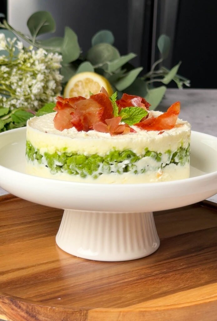 ricotta pea timbale topped with crispy prosciutto and fresh mint garnish