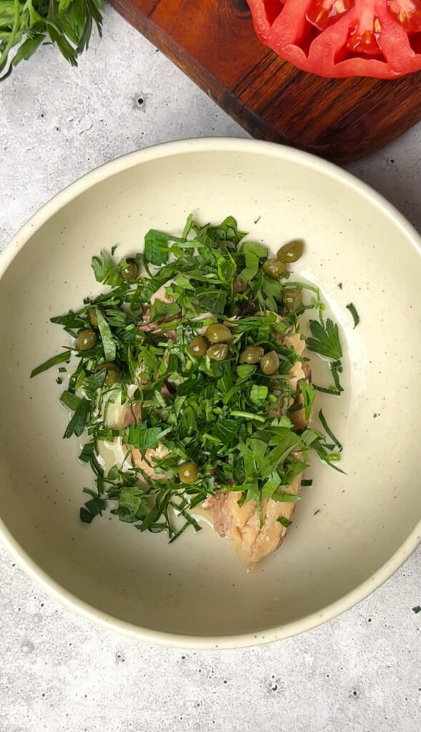 sardines with fresh parsley, capers and olive oil ready to mix