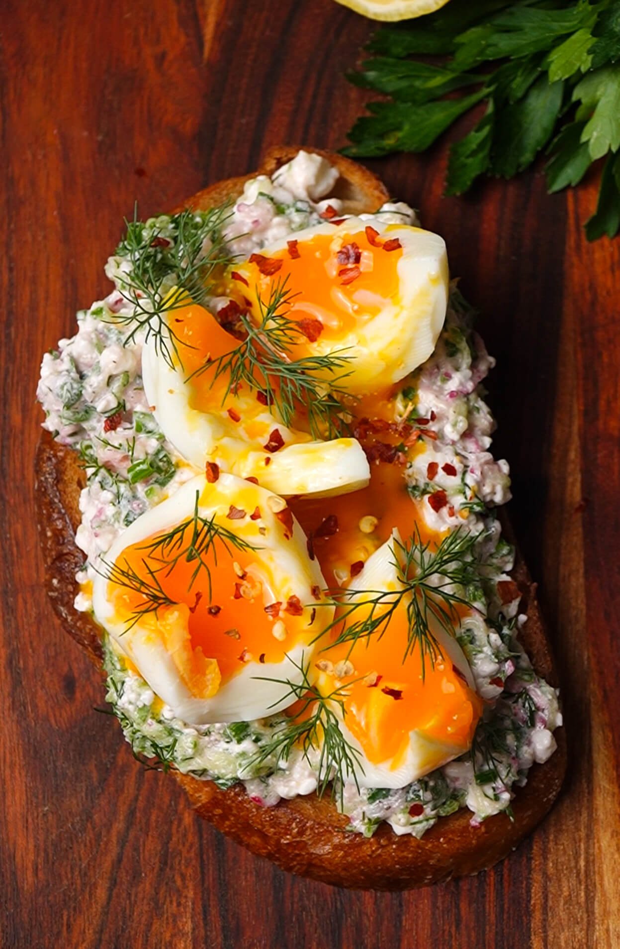 Spring garden toast with jammy eggs, fresh dill, and red pepper flakes