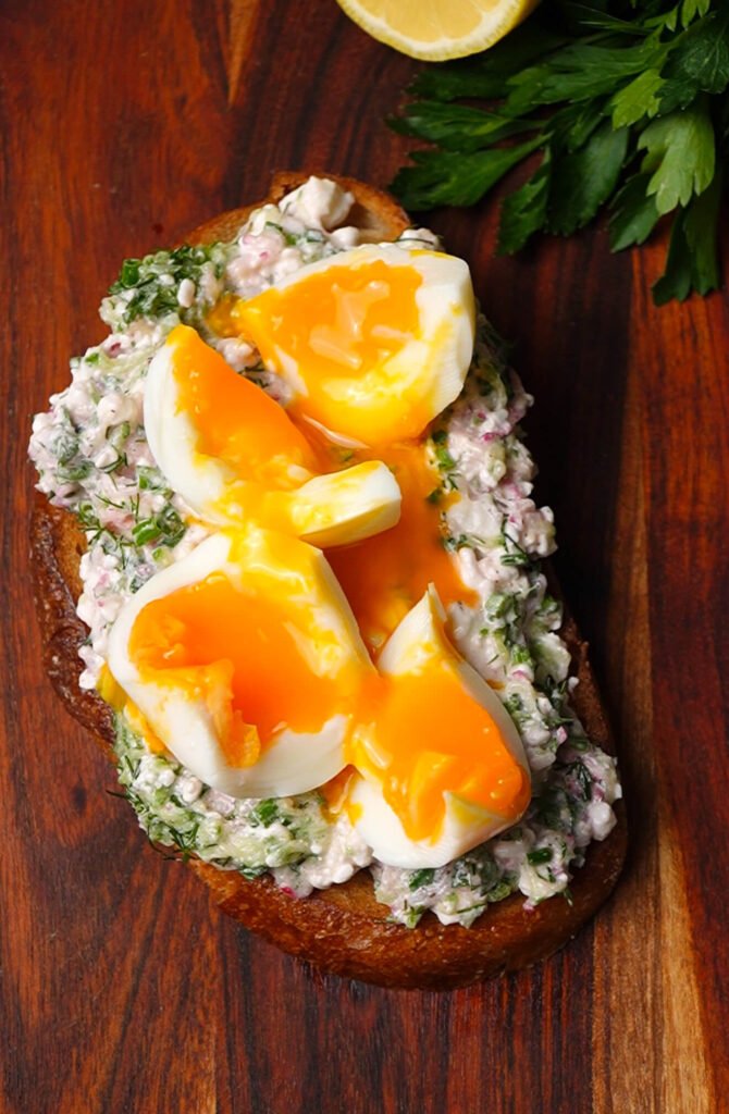 Spring toast topped with jammy eggs and creamy cottage cheese mixture