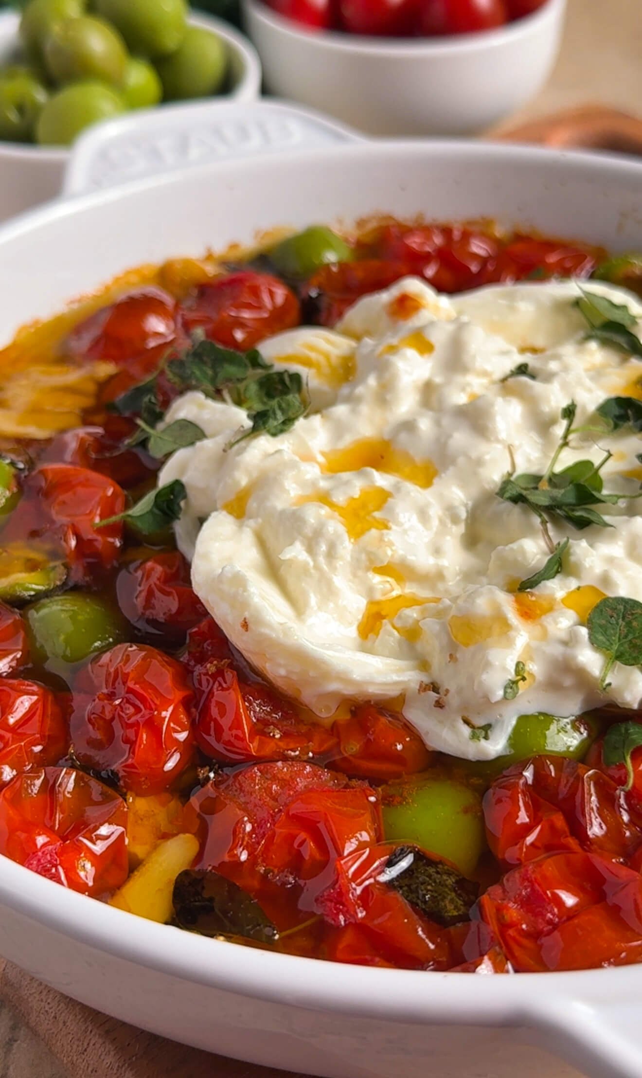 jammy roasted tomato burrata with olives served in baking dish