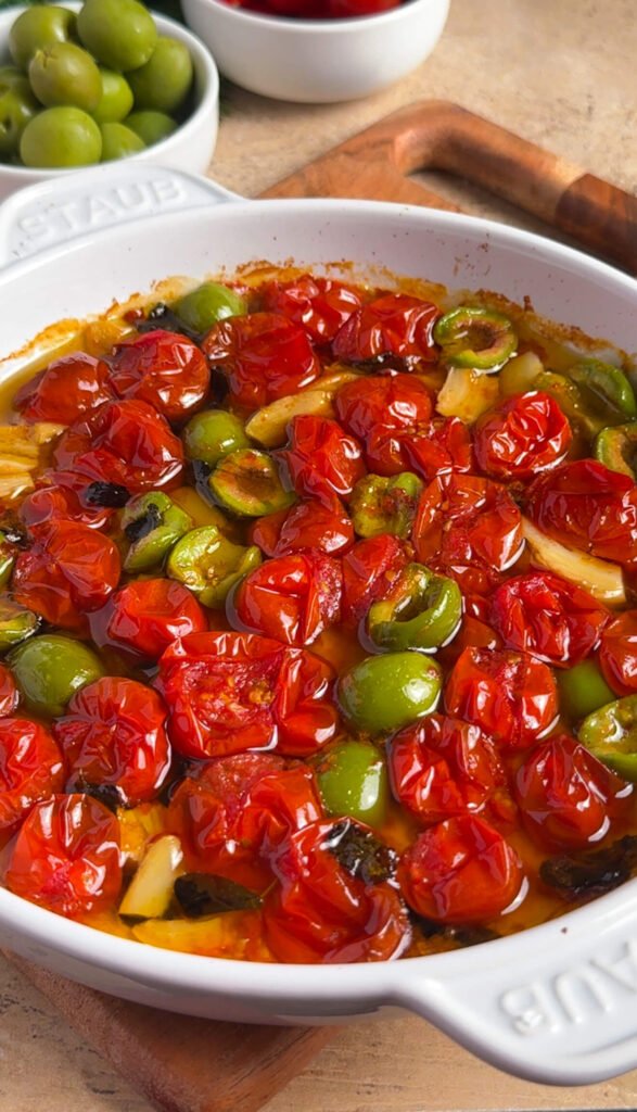 jammy roasted tomatoes with olives and garlic in olive oil, fresh out of the oven