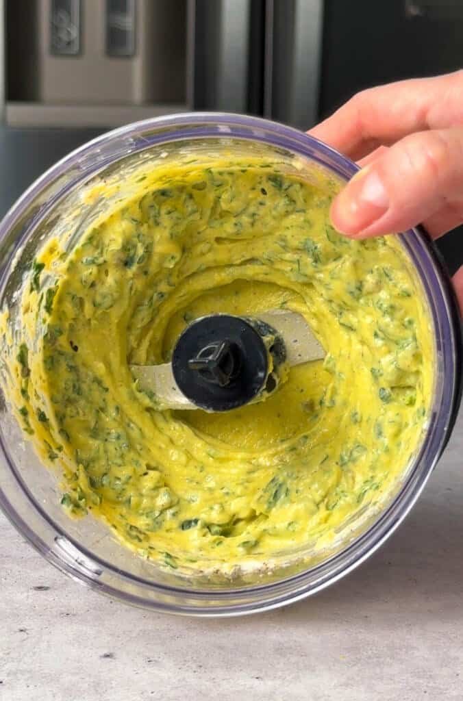 Smooth whipped egg, caper, and parsley spread blended in a food processor, flecked with green herbs