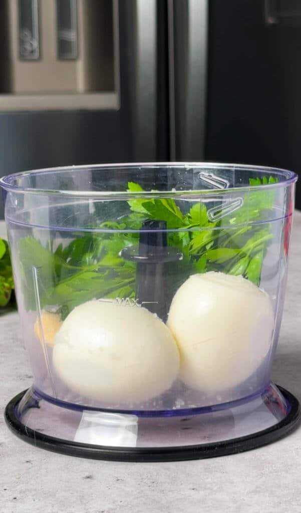 Hard-boiled eggs, fresh parsley, and Laughing Cow cheese in a food processor before blending the crostini spread