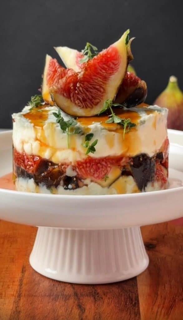 Gorgonzola fig and honey stack topped with fresh fig wedges, thyme, and a drizzle of hot honey