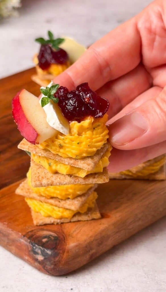 Butternut squash cheese cracker topped with Brie, apple, cranberry sauce and fresh thyme