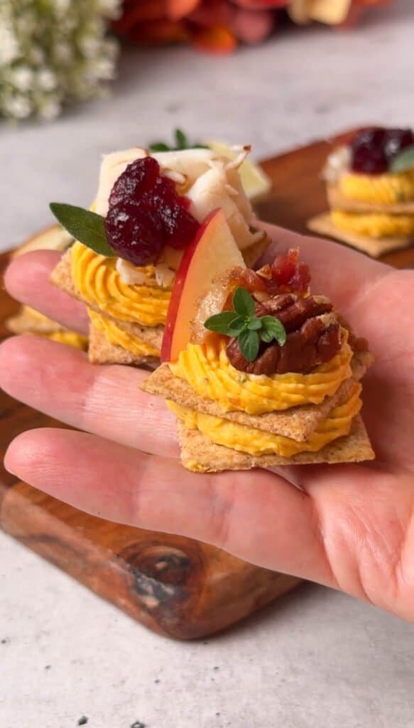 Fall butternut squash cracker appetizers with apple, pecan, turkey and cranberry toppings